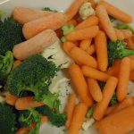 A platter of carrots, broccoli and cauliflower.